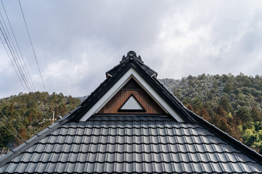 A decorative rooftop of a house in Japan