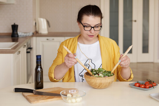 Young Woman Tossing Salad