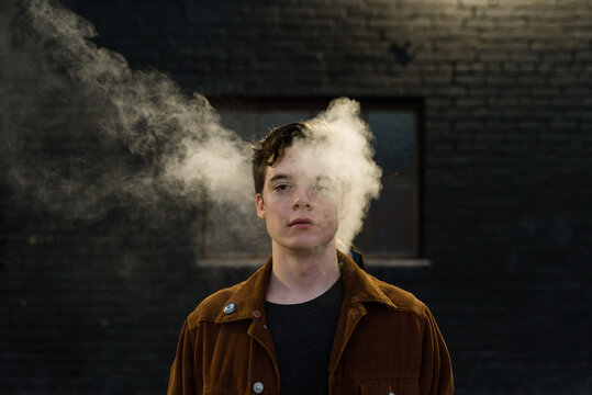 Portrait of young man with smoke around face