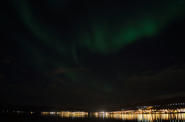 strong vibrant aurora borealis, northern light in autumn night in the arctic circle