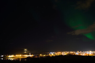 Fototapeta na wymiar beautiful aurora borealis over the arctic city of tromsoe on a late autumn night