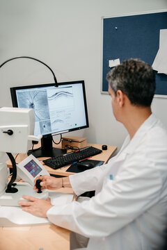 Doctor checking the results of the eye examination on the computer screen