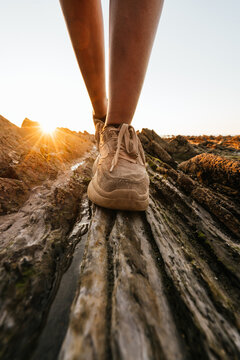 Close up of a legs walking on rocks, Flysch, Sakoneta beach, Basque Country.