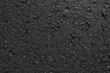 A smooth dark grey asphalt pavement texture with small rocks. Black bituminous waterproofing....