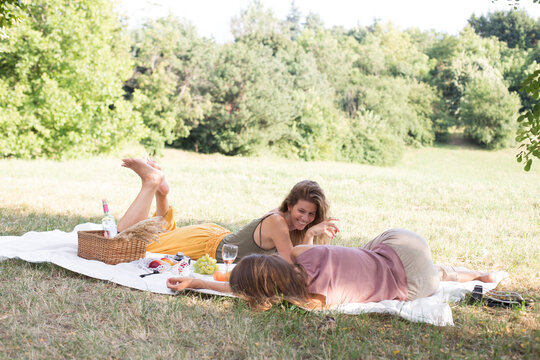 Two girls are having a picnic in the nature