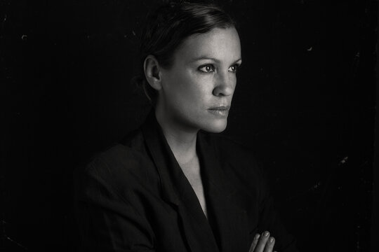 Business woman in black and white over black background.
