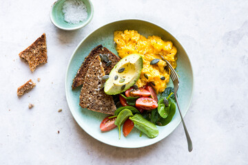 Weekend Brunch with creamy scrambled eggs, toast, avocado, spinach