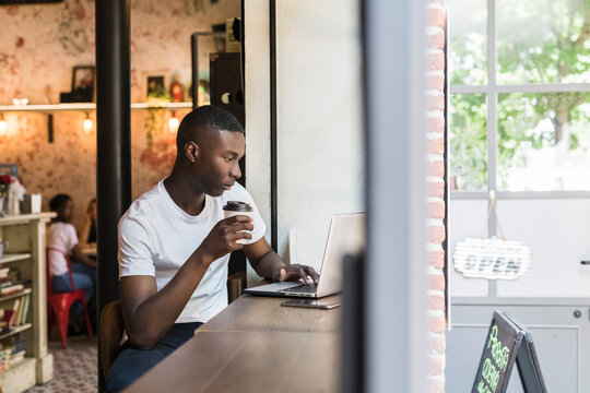 Young man working and studying at coffee shop