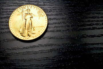 Liberty inscription on a gold 1 ounce American Eagle coin made in the US mint.