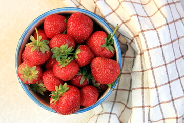 plate with a mound of freshly picked strawberries