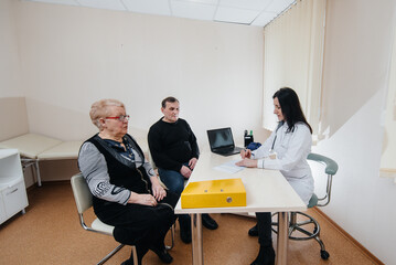 A couple of elderly people at a personal doctor's appointment at a medical center. Medicine and healthcare