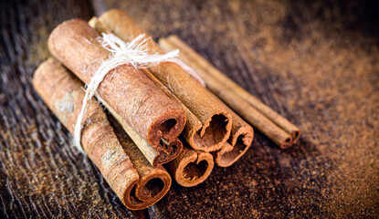 cinnamon bark, used in teas, sweets, as a flavoring or culinary ingredient. Cinnamon on rustic...
