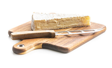 Brie cheese. White soft cheese with white mold on wooden cutting board