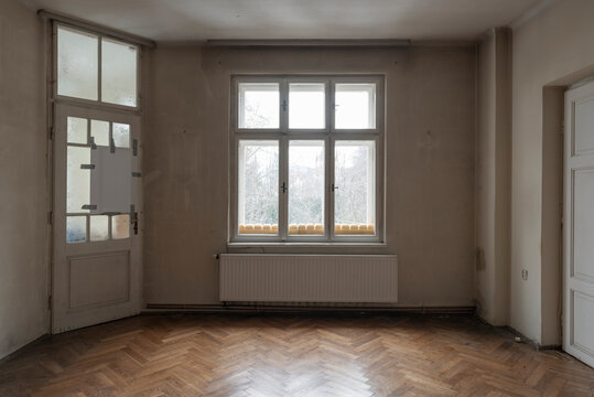 Perpendicular view huge window and two doors in antique house