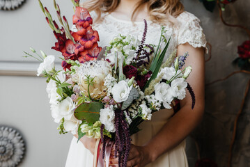 Beautiful and sophisticated wedding bouquet close-up holds the bride in her hands. Wedding bouquet