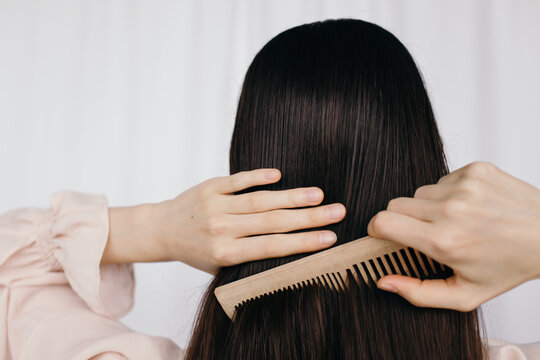 Anonymous woman combing hair