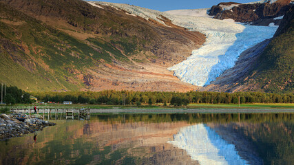 Fototapeta na wymiar Svartisen Glacier landscape on a sunny day, blue ice in the rocky mountains