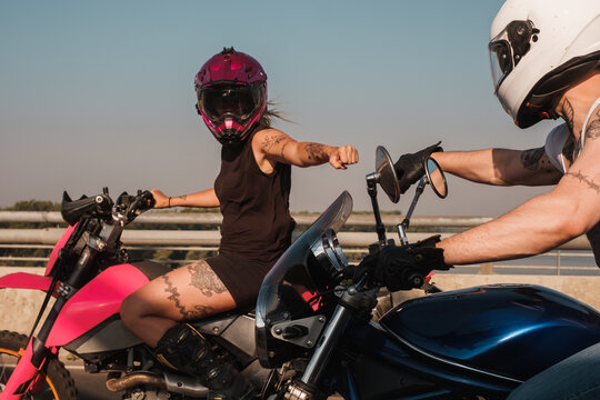 Male And Female Motorcyclists Riding Together