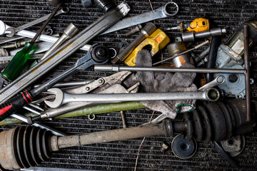 Old tools on floor in workshop, Tool in vintage garage style. Flat lay Old hand tools ,Pliers screwdriver wrench rusted iron metal tools on Steel plate at garage