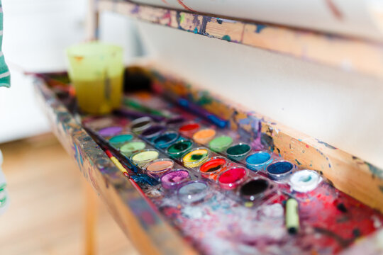 messy paint tray on easle