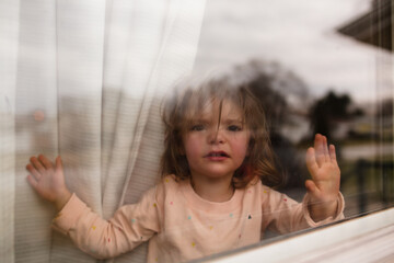 little girl looking out window