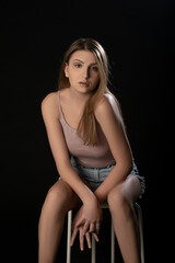 Beautiful girl posing on black background. Isolated, Face Expression