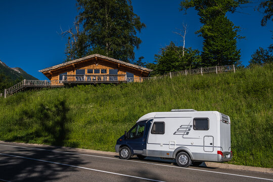 A house on wheels. A motorhome. Rv. Camper. Rest in the mountains. A residential van. Independence. High mountains. Freedom. Tourism. Journey.