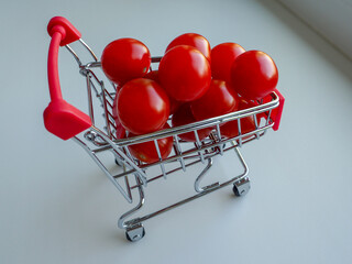 mini supermarket cart filled with small cherry tomatoes
