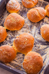 Top view fresh hot homemade buns on baking tray