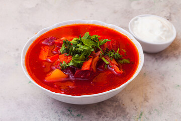 Delicious red borsch with herbs and sour cream