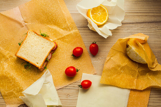 Top view handmade recycable beeswax wraps on wooden surface