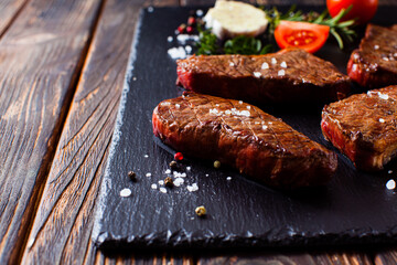 Medium pieces of fresh steak prepared on a grill