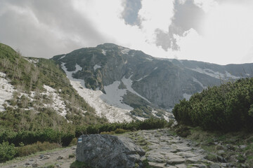 Panoramic view on mouintain peak from foothills. Footpath.