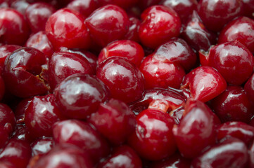 Red juicy cherry berries in sugar syrup. Pitted fruits. Making jam, canning products at home. Food. Close-up. Background, selective focus