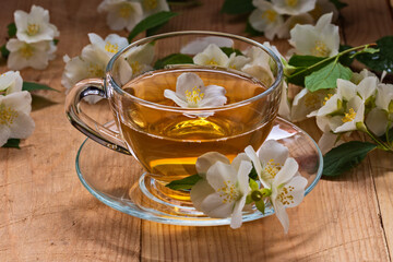 Fresh white jasmine flowers on a wooden table. Jasmine tea.
