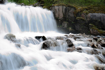 Fototapeta premium beautiful waterfall flowing over rocks and stones