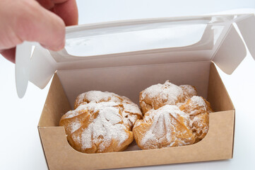 sweet cakes in a disposable protective cardboard box for the delivery of bakery products