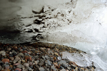 massive ice block on river shore