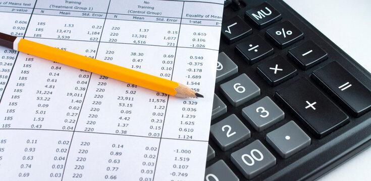 Financial planning with calculator and pencil on data