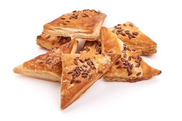 Puff pastry pies coated with flaxseeds, isolated on white background
