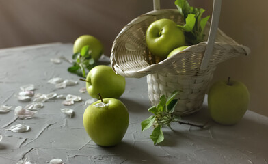 Fresh green apples, wicker basket, selective focus
