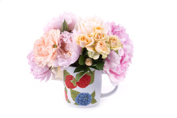 Peonies and roses in a ceramic cup