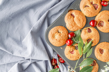 Newly baked  cherry muffin on a muffin tray