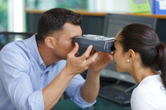 Ophthalmologist Measuring Intraocular Pressure Of Young Woman In Clinic