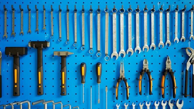 Garage tools hanging on the organizer wall. Loopable animation. Workshop. 4K HD