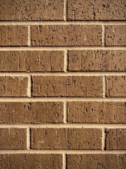 brickwork, brown brick wall of an urban building, background for wallpaper, image, postcards and magazines, blogs, online catalogs and advertising, design