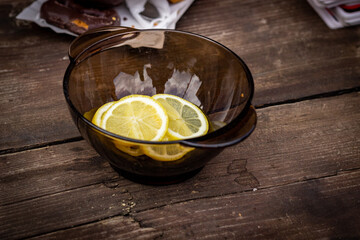 A plate with slices of lemon on a wooden table