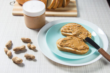 Two peanut butter sandwiches. Two slices of bread with peanut butter.