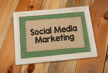 Social Media marketing words wrriten on wood slate and wooden background.