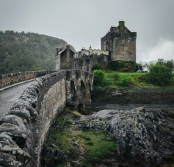 Old historic Eilean Donan Castle in Scotland UK. Stone bridge to the castle.